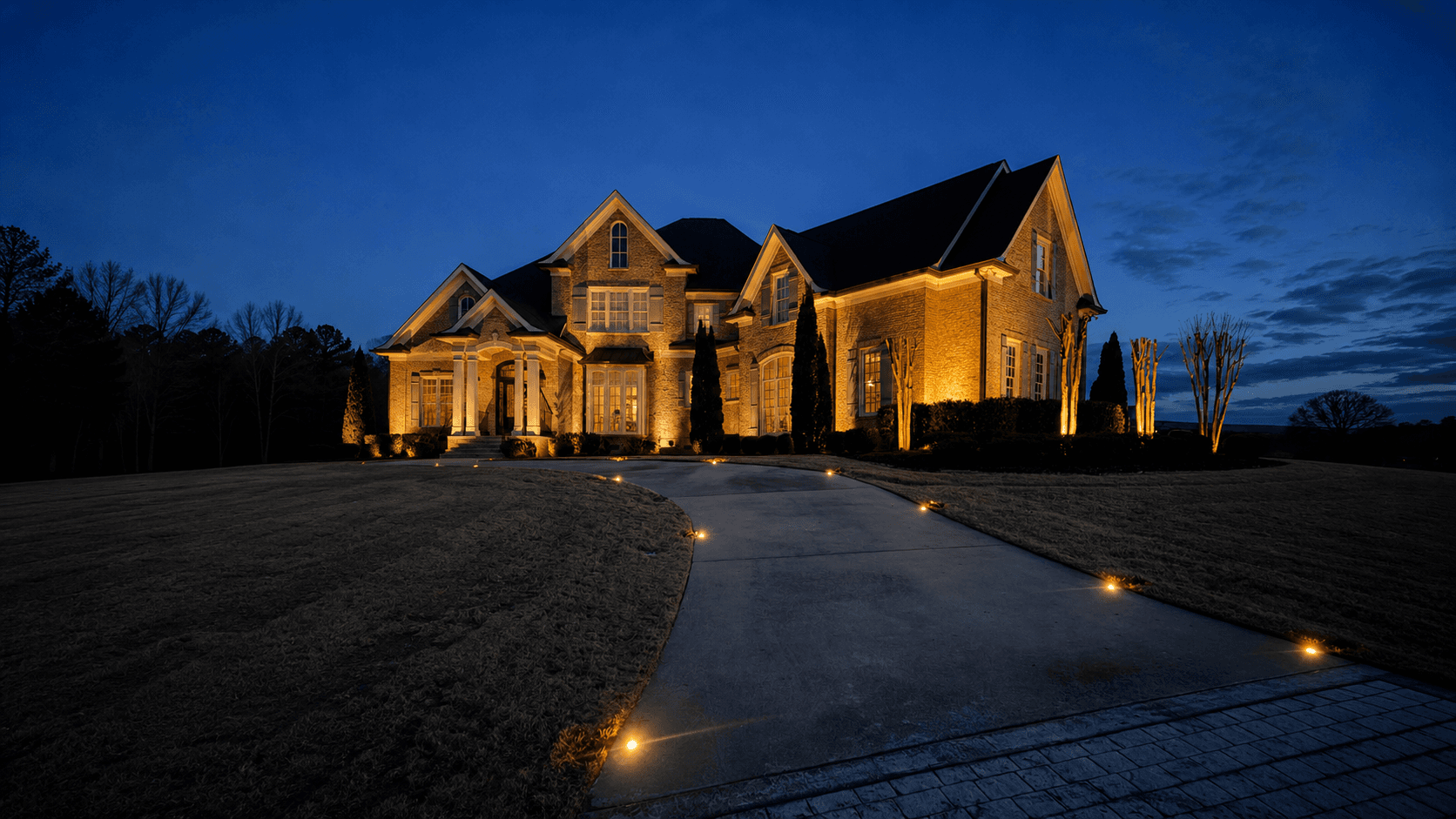 Landscape lighting highlighting a luxury home exterior